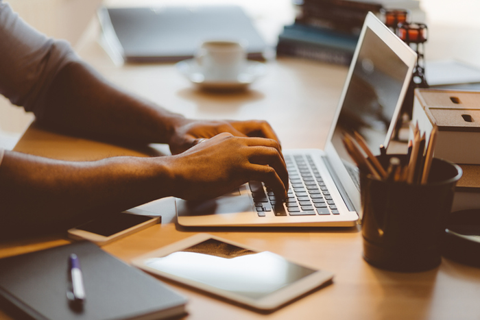 shot of hands typing on a laptop computer