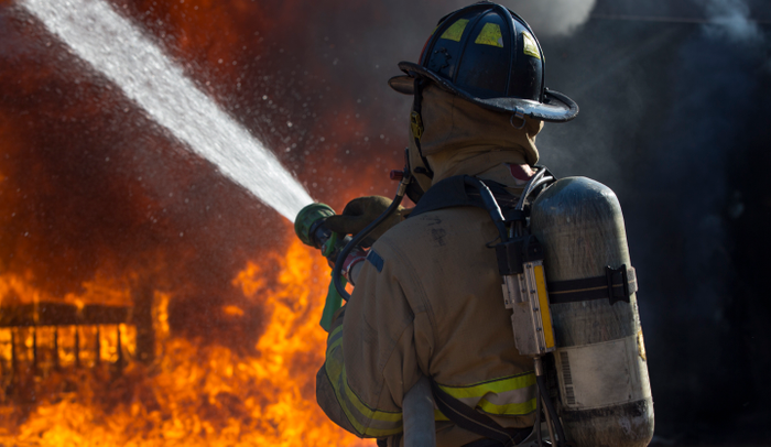 Fireman putting out a bedroom fire