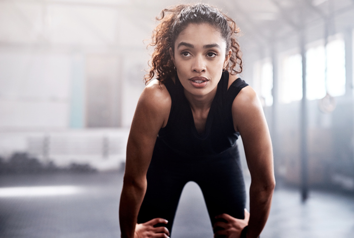 woman in exercise clothes in big open room