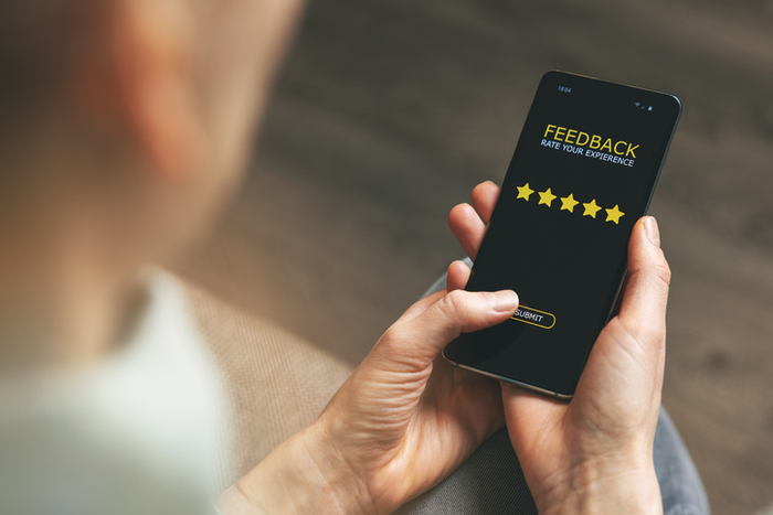 man using a smartphone to respond to a survey